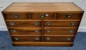 A REPRODUCTION CAMPAIGN STYLE MEDIA CABINET, with a hinged lid, a fall front door and double