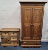 A MODERN PINE DOUBLE DOOR WARDROBE, atop a base with a single drawer, along with a cabinet with four