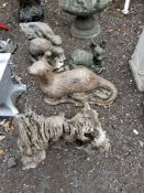 A SMALL DRIFTWOOD GARDEN ORNAMENT with a resin squirrel figure mounted, 43cm high, a concrete