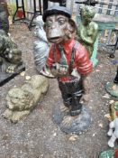 A PAINTED CONCRETE GARDEN FIGURE DEPICTING A CHARACATURE CHIMPANZEE in overalls and a pipe, 84cm