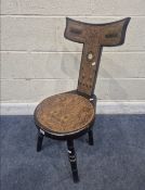 AN ARTS AND CRAFTS POKERWORK SPINNING CHAIR, with geometric inlay, circular mother of pearl to the