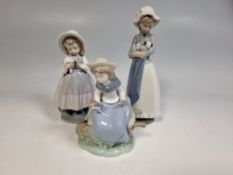 A GROUP OF THREE NAO BY LLADRO FIGURES comprising 'Girl with Bouquet' (Nina Com Ramo) modelled as