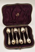 A CASED SET OF SIX EARLY 20TH CENTURY TEASPOONS, each with a decorative open work floral handle,