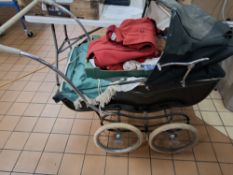 A MARMET PRAM AND A BOX OF CHILDREN'S CLOTHES, the pram in need of some attention, with dark green
