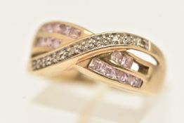 A YELLOW METAL GEM SET CROSS OVER RING, set with a row of small single cut diamonds and square cut