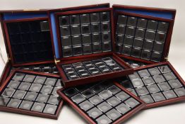 3 Collectors coin cases. Each Case Contains 3 Trays. There are also a number of coin capsules. Cases
