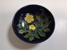 A SMALL MOORCROFT POTTERY FOOTED BOWL OF THE BUTTERCUP PATTERN BY SALLY TUFFIN CIRCA 1990, tube-