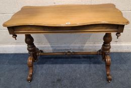 A 19TH CENTURY WALNUT SIDE TABLE, with a wavy edge, raised on turned supports with cabriole legs