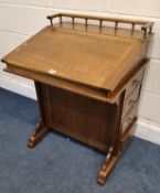 A REPRODUCTION DAVENPORT, with a raised gallery, a hinged lid above four double-sided drawers