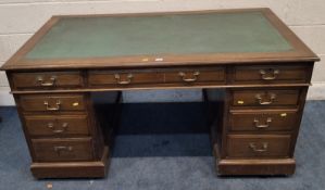 AN EARLY 20TH CENTURY MAHOGANY TWIN PEDESTAL DESK, with a leather writing surface, fitted with