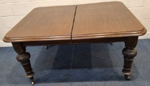 A VICTORIAN MAHOGANY WIND OUT DINING TABLE, with two additional leaves, raised on turned and