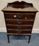 AN EDWARDIAN MAHOGANY MUSIC CABINET, with a raised gallery, fitted with four fall-front drawers,