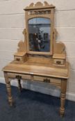 A PINE AND SATINWOOD WASHSTAND, with an arched mirror, four assorted drawers, raised on turned