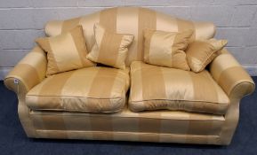 A YELLOW STRIPED UPHOLSTERED TWO SEATER SOFA, with an arched back, raised on bun feet Dimensions: