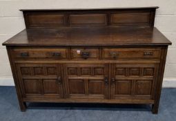 AN EARLY 20TH CENTURY OAK SIDEBOARD, with a raised back, fitted with three assorted drawers, over