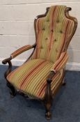 A VICTORIAN ROSEWOOD ARMCHAIR, with striped upholstery, a scrolled top and armrests, raised on