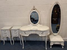 A CREAM FRENCH FOUR PIECE BEDROOM SUITE, comprising a kidney dressing table, with an oval mirror and