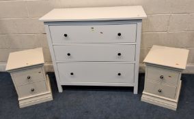 A MODERN WHITE CHEST OF THREE DRAWERS, along with a pair of cream two-drawer bedside chests