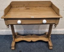 A 19TH CENTURY PINE WASH STAND, with raised back and sides, raised on trestle-style legs, united