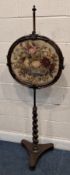 A REGENCY MAHOGANY POLE SCREEN, with a height-adjustable circular screen, with scrolled details to