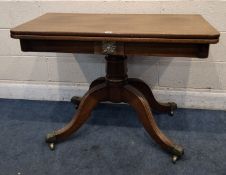 A REGENCY MAHOGANY TEA TABLE, with a rotating fold-over top, raised on a single pedestal with four