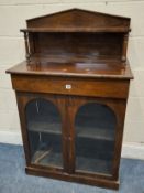 A VICTORIAN ROSEWOOD CHIFFONIER, the raised back with a single shelf, atop a base with two arched