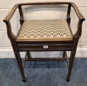 AN EDWARDIAN MAHOGANY AND BOX STRUNG PIANO STOOL with open back and sides surrounding a hinged seat,