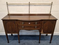 AN EDWARDIAN MAHOGANY AND INLAID SIDEBOARD, with a raised brass top, a curved front, fitted with two