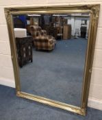 A GILT WOOD RECTANGULAR BEVELLED EDGE WALL MIRROR, with scrolled and foliate details Dimensions: