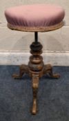 A VICTORIAN PIANO STOOL, the height-adjustable swivel seat with later upholstery, raised on three