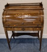 AN EDWARDIAN ROSEWOOD AND MARQUETRY CYLINDER TOP BUREAU, with a raised gallery, the door enclosing a