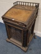 X AN EARLY 20TH CENTURY OAK DAVENPORT, with scrolled, geometric and foliate carved details all over,