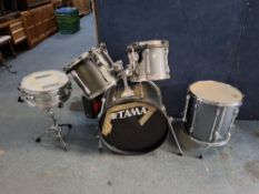 A TAMA ROCKSTAR FIVE PIECE DRUM KIT with a 22x16 kick drum with legs, 16x16 floor tom with spurs,