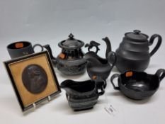 A GROUP OF BLACK BASALT POTTERY BY WEDGWOOD AND OTHERS, comprising a late 18th century coffee pot,