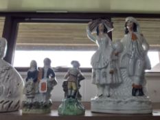 A GROUP OF STAFFORDSHIRE FIGURES, comprising a Walton pearlware figure of a man with a barrel (