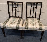 A PAIR OF GEORGE III HEPPLEWHITE STYLE CHAIRS, with floral upholstered seats, raised on square,