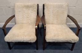 POSSIBLY TOOTHILL, A PAIR OF TEAK AFROMOSIA LOW ARMCHAIRS, with open armrests, webbed seats,
