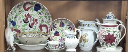 A GROUP OF HAND - PAINTED POTTERY ITEMS, comprising a selection of 19th and mid 20th century jugs,