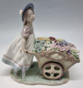 A LLADRO 'LOVE'S TENDER TOKENS' FIGURE, no 6521, depicting a girl pushing a wheelbarrow of