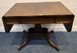 A REGENCY ROSEWOOD SOFA TABLE, with brass inlay, a single frieze drawer, raised on a block