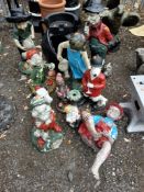 A COLLECTION OF PLASTIC GARDEN FIGURES, including a seated boy 56cm high, a concrete gnome, dwarves,