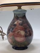A MOORCROFT POTTERY 'FINCHES AND FRUIT' PATTERN TABLE LAMP, tube-lined with purple finches perched