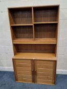 A MID-CENTURY TEAK WALL UNIT, with two adjustable shelves, atop a base with double cupboard doors