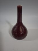 A CHINESE FLAMBE GLAZED 'SANG DE BOEUF' VASE CIRCA 20th CENTURY, of classic tianqiuping form, the
