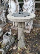A WEATHERED CONCRETE SUN DIAL, the circular top with a brass dial, held aloft by a putti, height