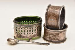 A SILVER SALT AND TWO SILVER NAPKIN RINGS, the oval pierced salt raised on four ball feet with a