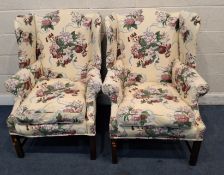 A PAIR OF REPRODUCTION WINGBACK ARMCHAIRS, with cream and foliate upholstery Dimensions:width 80cm x