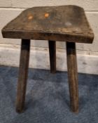 A PRIMITIVE STYLE CUTLERS STOOL, raised on three legs Dimensions:width 31cm x depth 30cm x height