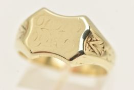 A YELLOW METAL SIGNET RING, shield design with patterned shoulders, stamped 14k MA, ring size U 1/