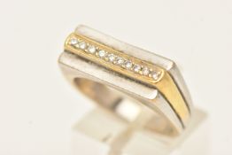 A HEAVY BI-COLOUR DIAMOND SET RING, yellow and white metal ring set with a row of ten small round